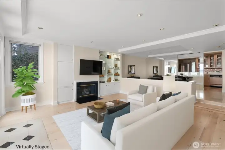 The step-down living room is just off the formal dining room, with the kitchen located beyond, creating a seamless flow that's ideal for both everyday living and entertaining. The step-down living room is just off the formal dining room, with the kitchen located beyond, creating a seamless flow that's ideal for both everyday living and entertaining.
