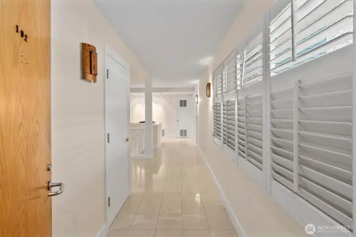 Enter to gleaming tile floors and elegant plantation shutters in this light-filled residence. Water views can be enjoyed from both the living area and the primary bedroom. Enter to gleaming tile floors and elegant plantation shutters in this light-filled residence. Water views can be enjoyed from both the living area and the primary bedroom.