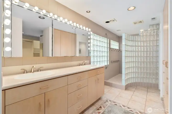 Primary bath with tile floors, dual sinks and walk in shower. Primary bath with tile floors, dual sinks and walk in shower.