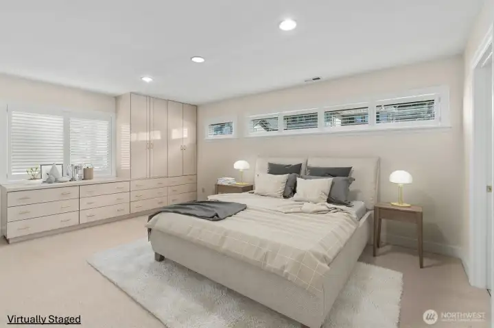 Another view of the second en-suite bedroom showcasing built-in cabinetry and abundant natural light. Another view of the second en-suite bedroom showcasing built-in cabinetry and abundant natural light.