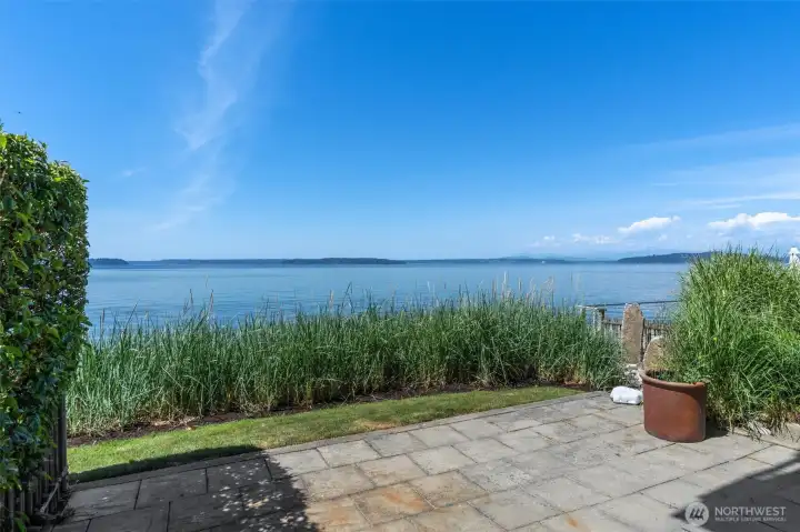 Your private patio extends seamlessly from the living room to a beautifully landscaped lawn at the water's edge. Your private patio extends seamlessly from the living room to a beautifully landscaped lawn at the water's edge.