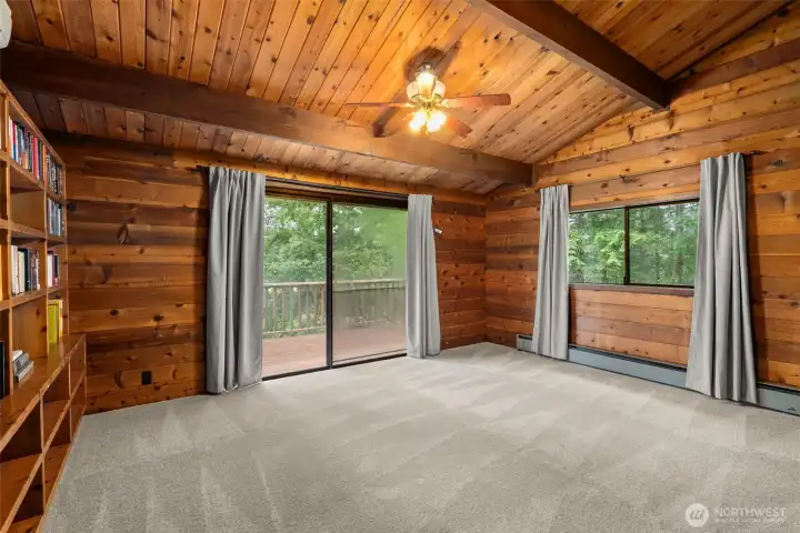 Main level primary bedroom with private deck