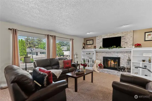 Great room living with built ins, centrally located wood-burning fireplace