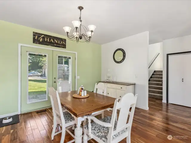 French doors to the back, hallway stairs lead to the upper room(s)/loft and enclosed rooftop.