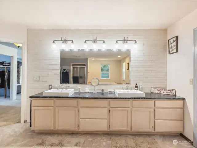 Double vanity with plenty of light. Separate soaking tub, shower, toilet & bidet.