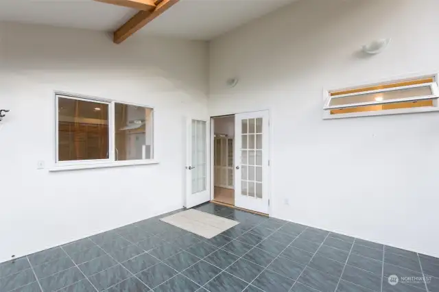 Sunroom with window to kitchen