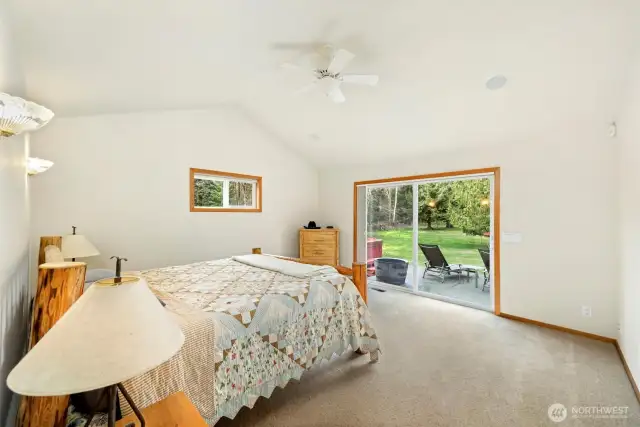 The primary suite has vaulted ceilings with direct access to the patio and hot tub