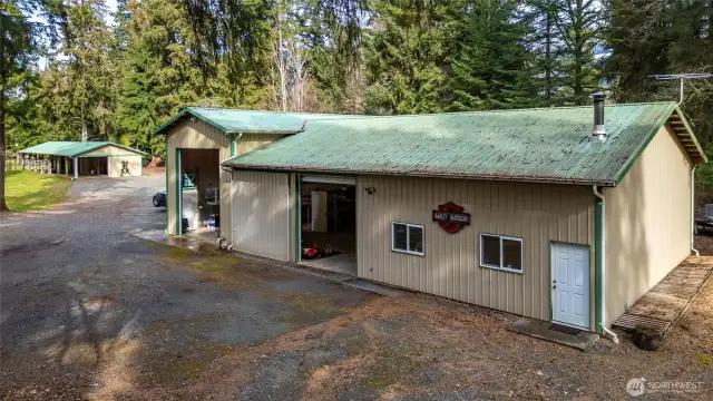 The large shop with horse barn in the distance, which sits adjacent to the home.