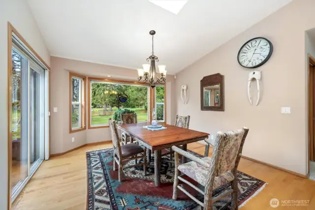Dining area adjacent to the kitchen and overlooks the beautiful patio and sweeping acreage