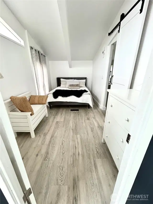 Primary room.  New Queen bed with barn door to gorgeous remodeled bathroom.