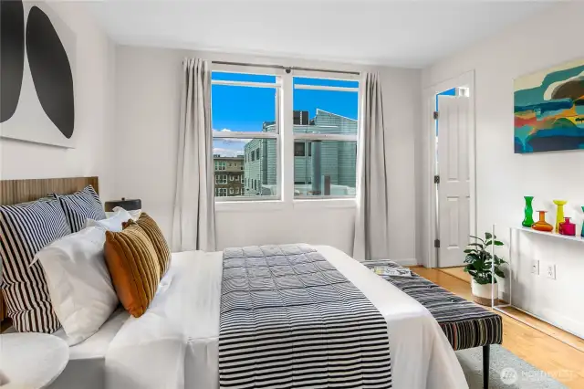 Two bedrooms with oversized windows and walk in closets are ideally positioned on opposite corners of the home for privacy —the owner’s suite with en suite bath and a second bedroom plus additional full bath.