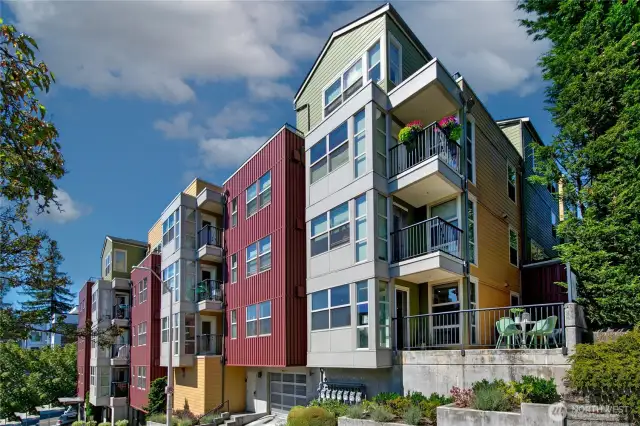 Live at the junction of Fremont & Wallingford, in a rare corner residence where indoor and outdoor space blend seamlessly as the vibrant energy of Stone Way unfurls below. Pitch a hammock for two as the sunset paints the sky, cultivate an urban garden, or dine al fresco with friends (and Fido) on the 450 SF private terrace. This oasis flows into a light-filled, south-facing interior with an enchanting fireplace, gleaming hardwoods, and chef’s kitchen. Two bedrooms, positioned at opposite corners, ensure privacy. Celebrate the 4th of July under a sky full of fireworks on the rooftop deck with Lake Union views. The pet-friendly boutique building offers a welcoming lobby/mailroom, storage room and dedicated parking in secure garage.