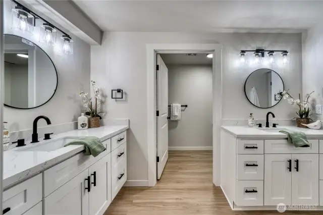This stunning bathroom offers separate vanities and private shower/tub, toilet area. So fun with new cabinets, quartz tops, lighting and more...