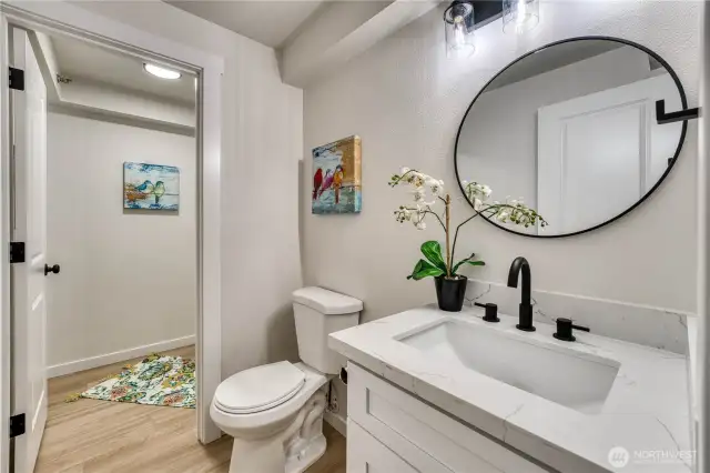 Charming all new half bath with an extra storage room.
