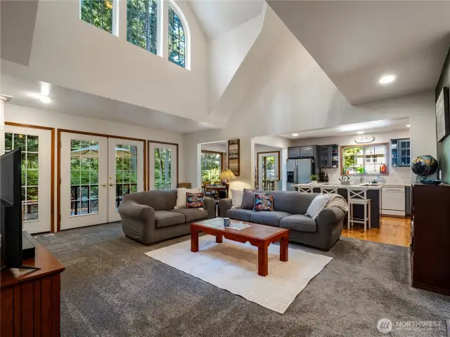 The large windows offer stunning views of the forest behind this house.