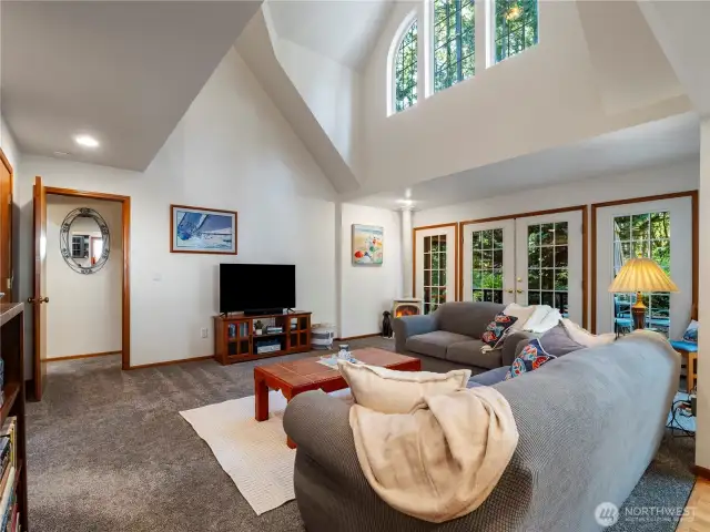 The living room is spacious and opens out onto the back deck.