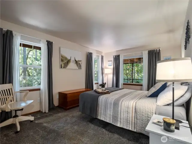 The large primary suite is located just off the living room on the main floor.