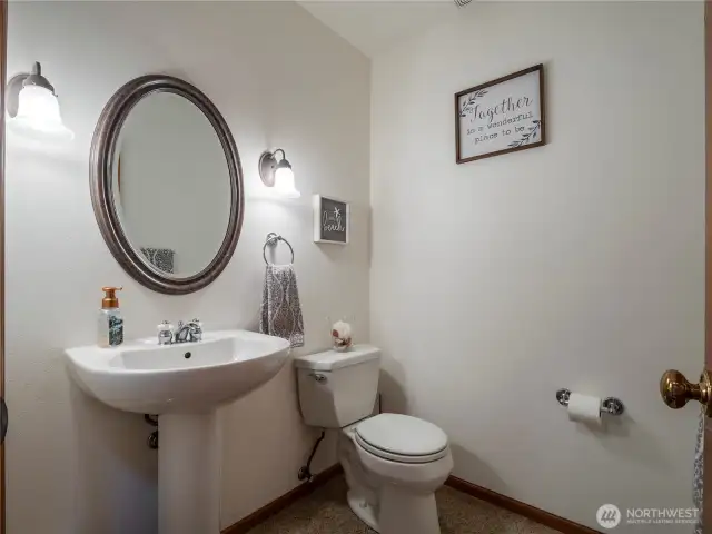 The half bath is located centrally on the main floor, so guests don't have to go upstairs or into the primary suite.