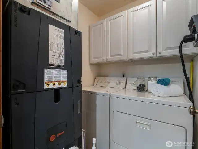 The laundry room is located off the primary suite bathroom on the main floor.