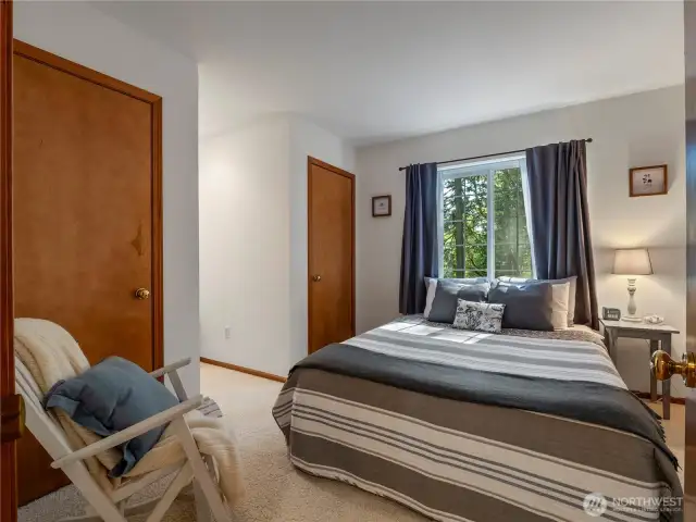 The upstairs bedrooms have dual closets and a window seat nook overlooking the woods across the street.