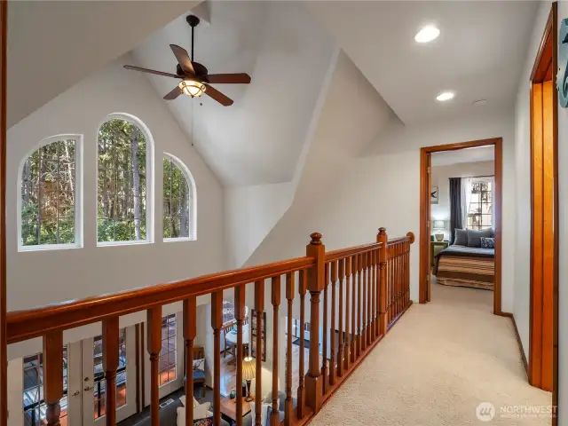 The upstairs hall has a beautiful view of the forest.
