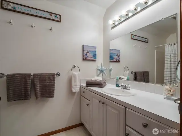 The upstairs full bathroom has ample space and is located between the two bedrooms.