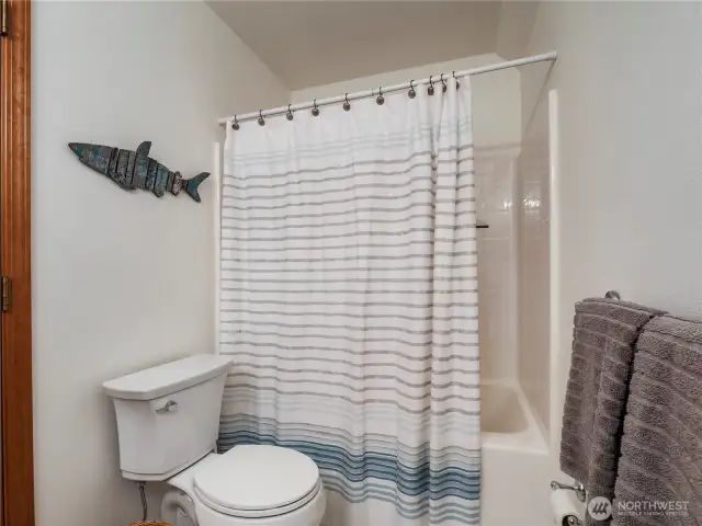 Upstairs, you'll find a full bathroom with a tub and a shower.