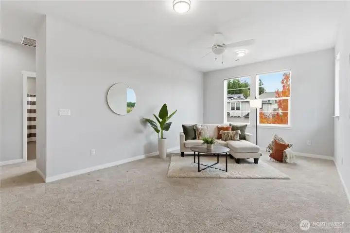 Light-filled spacious open area on the second floor perfect for a family room, craft area, exercise, play room...the perfect flex space!