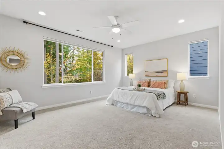 Cheery primary suite with views of the trees