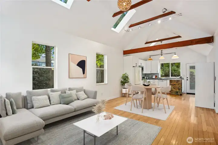 Welcome to this light-filled, open-concept main living space graced maple wood floors. Virtually staged to show ease of furniture placement.