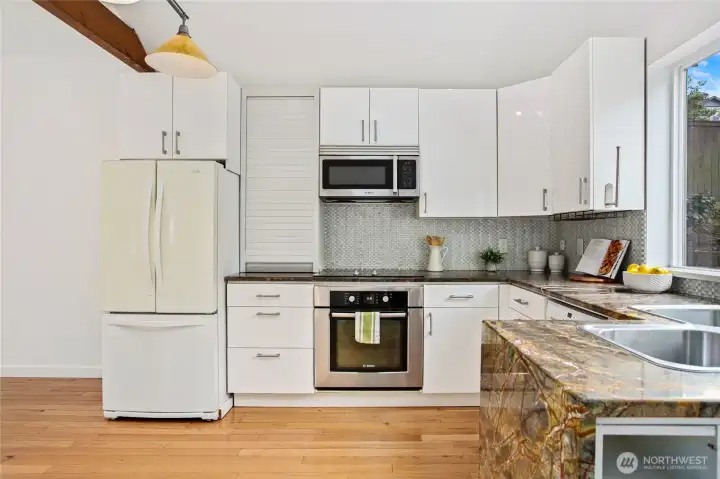 Ample storage including an appliance garage, & free-standing pantry (out of frame).  Enjoy your Bosch range, microwave, & dishwasher.