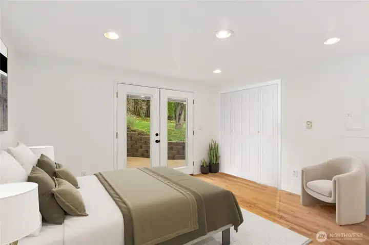 The spacious primary bedroom features French doors that lead to the back patio. **CLOSET DOORS ARE DIFFERENT THAN PHOTO. Current doors are wood and not painted. These are a virtual rendition of what they could look like.*  This room has been virtually staged.