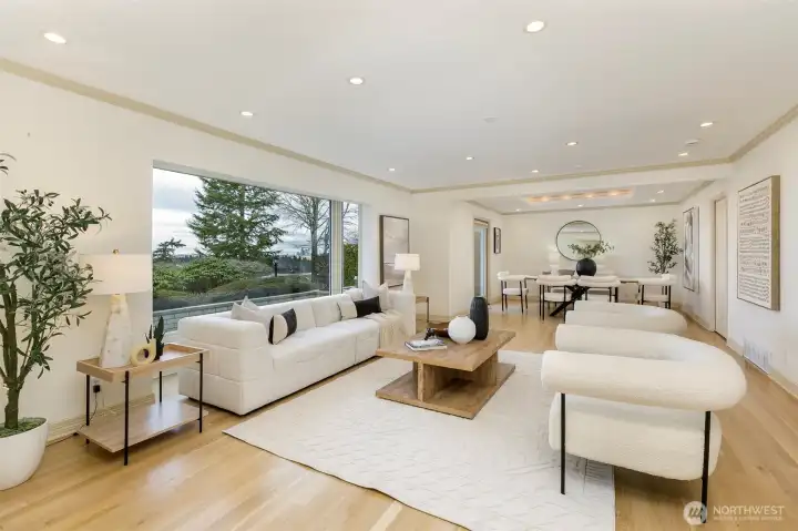 Huge living room with expansive picture window to western lake city and mountain views