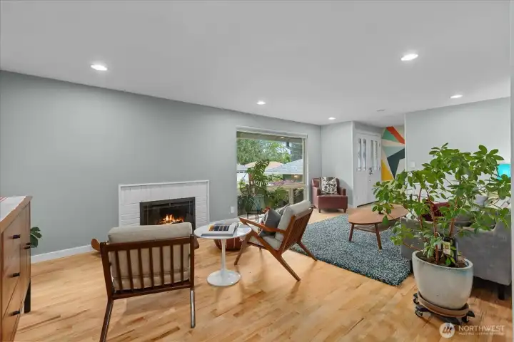 Another view of the living room with a second seating area by the fireplace - flexible living space provides ample room