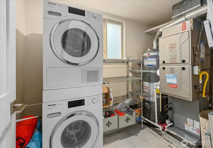 The laundry room features a stackable Miele washer/dryer set, gas water heater and gas furnace