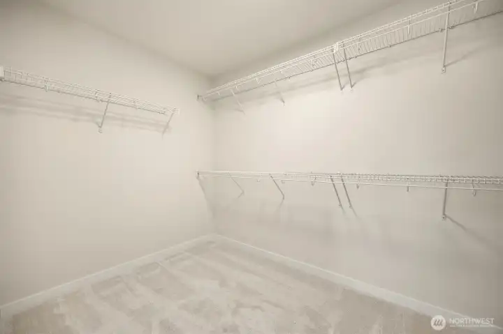 Wow! The primary bedroom walk in closet offers all the space you need and more.