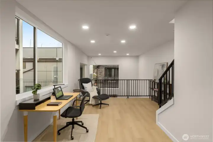 second perspective of the upper-level landing, emphasizing the architectural metal railings and flexible space planning. second perspective of the upper-level landing, emphasizing the architectural metal railings and flexible space planning.