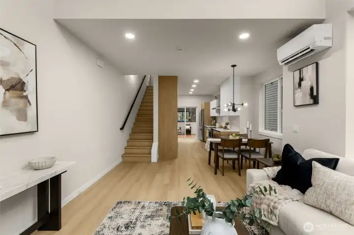 A warm and welcoming main-level view highlighting the seamless flow between the entry hallway and the home's open transitions. A warm and welcoming main-level view highlighting the seamless flow between the entry hallway and the home's open transitions.