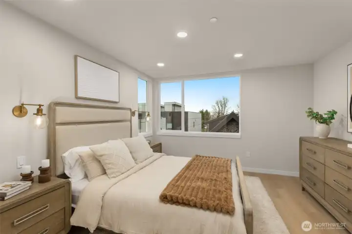 Serene and spacious primary bedroom retreat, flooded with natural light from large, beautifully placed windows. Serene and spacious primary bedroom retreat, flooded with natural light from large, beautifully placed windows.