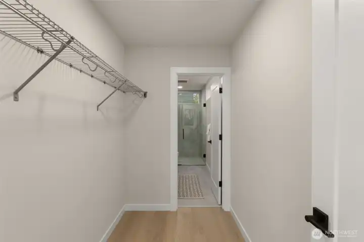 A pristine walk-in closet or storage space featuring clean, functional wire shelving and direct access to the upper level. A pristine walk-in closet or storage space featuring clean, functional wire shelving and direct access to the upper level.