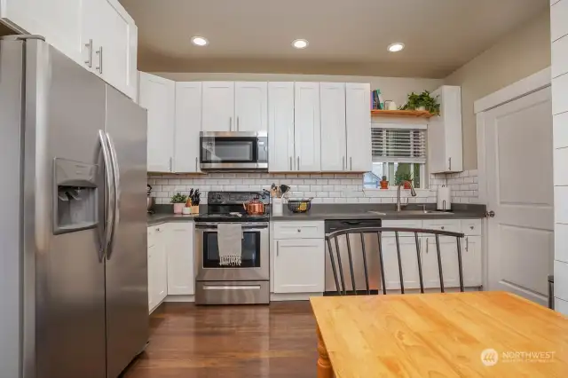 Beautifully updated kitchen with subway tile and quartz counters
