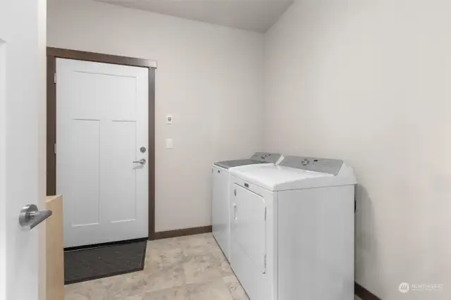 Laundry room off of garage on the primary suite end of house