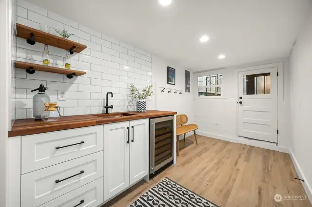 Wet bar and wine fridge on lower level next to family/media room. Exit to back patio for entertaining.