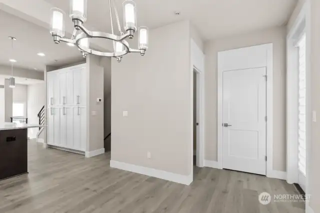 Powder bathroom and entry closet shown ahead on the right.