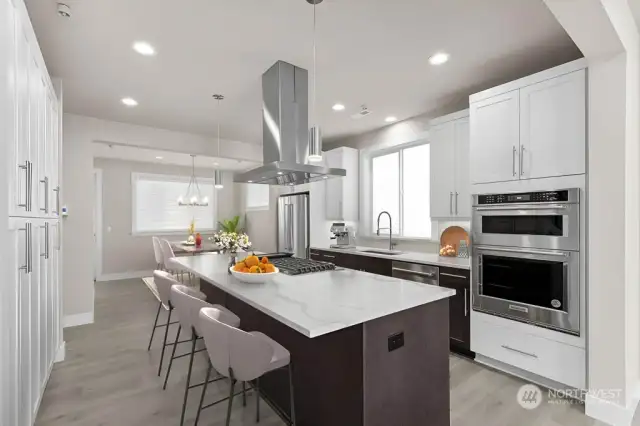 Virtual staging.  Thick slab quartz countertops, 5 burner gas range, two tone cabinetry w/ soft close cabinets, and full height tile backsplash!