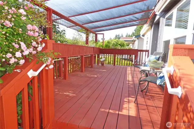 Sit, relax and smell the flowers on the deck under the removable shade.