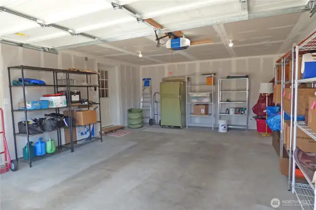 Attached double garage with remote opener. Shelving and frig stay too (still have items to remove).