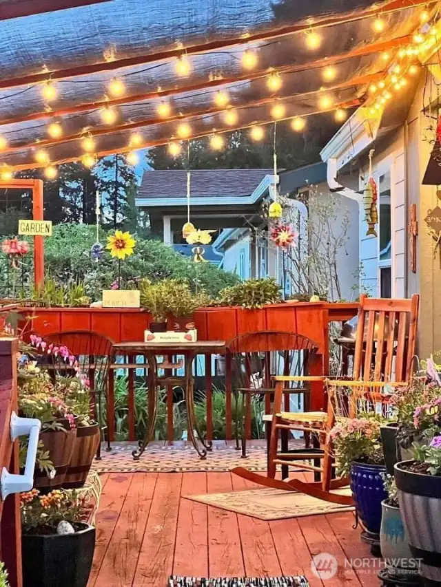 Deck at night with lights and removable awning. Photo from 2024.