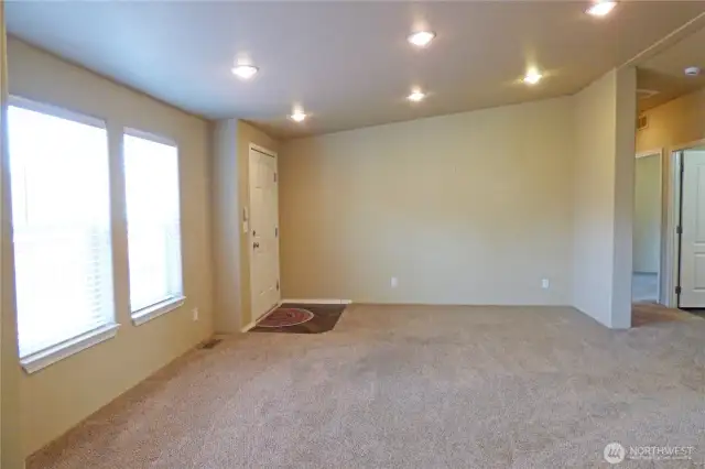 Another view of the living room. Hall leads to 2 bedrooms and full bathroom.