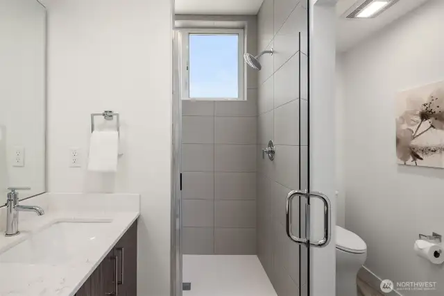 Walk in shower with lots of natural light, high ceilings and separate toilet area.